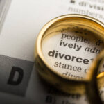 Divorce and separation concept. Two golden wedding rings. Dictionary definition